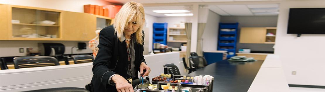 Clinical Research Coordinator looks at some vials in a Pima lab